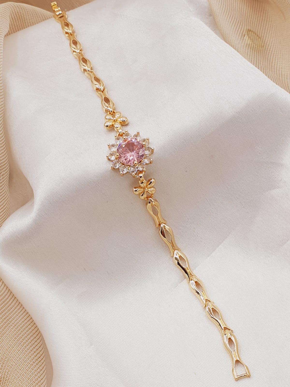 Gold plated bracelet with pink and white stones in unique style